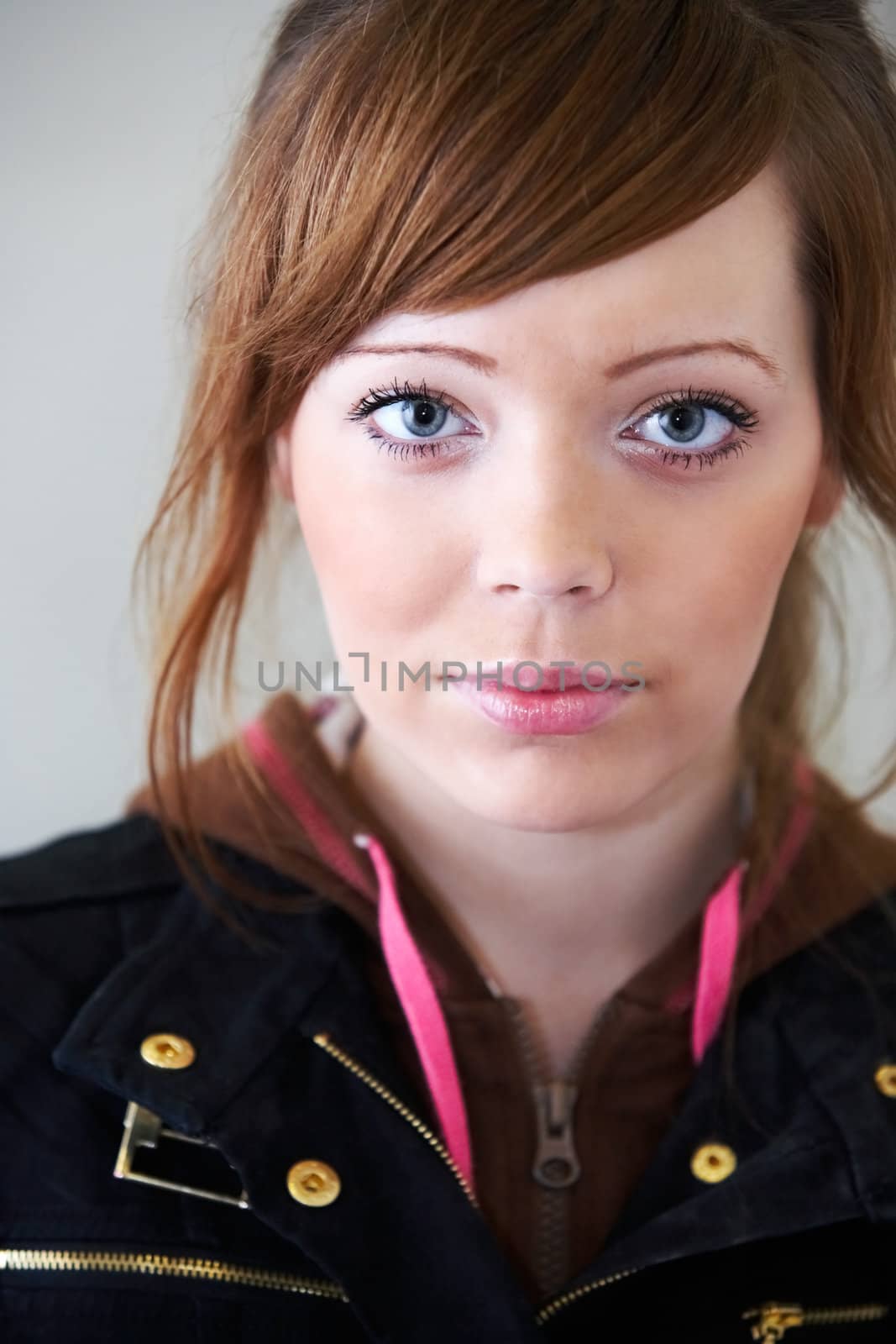 Teenage girl looking at camera, interior