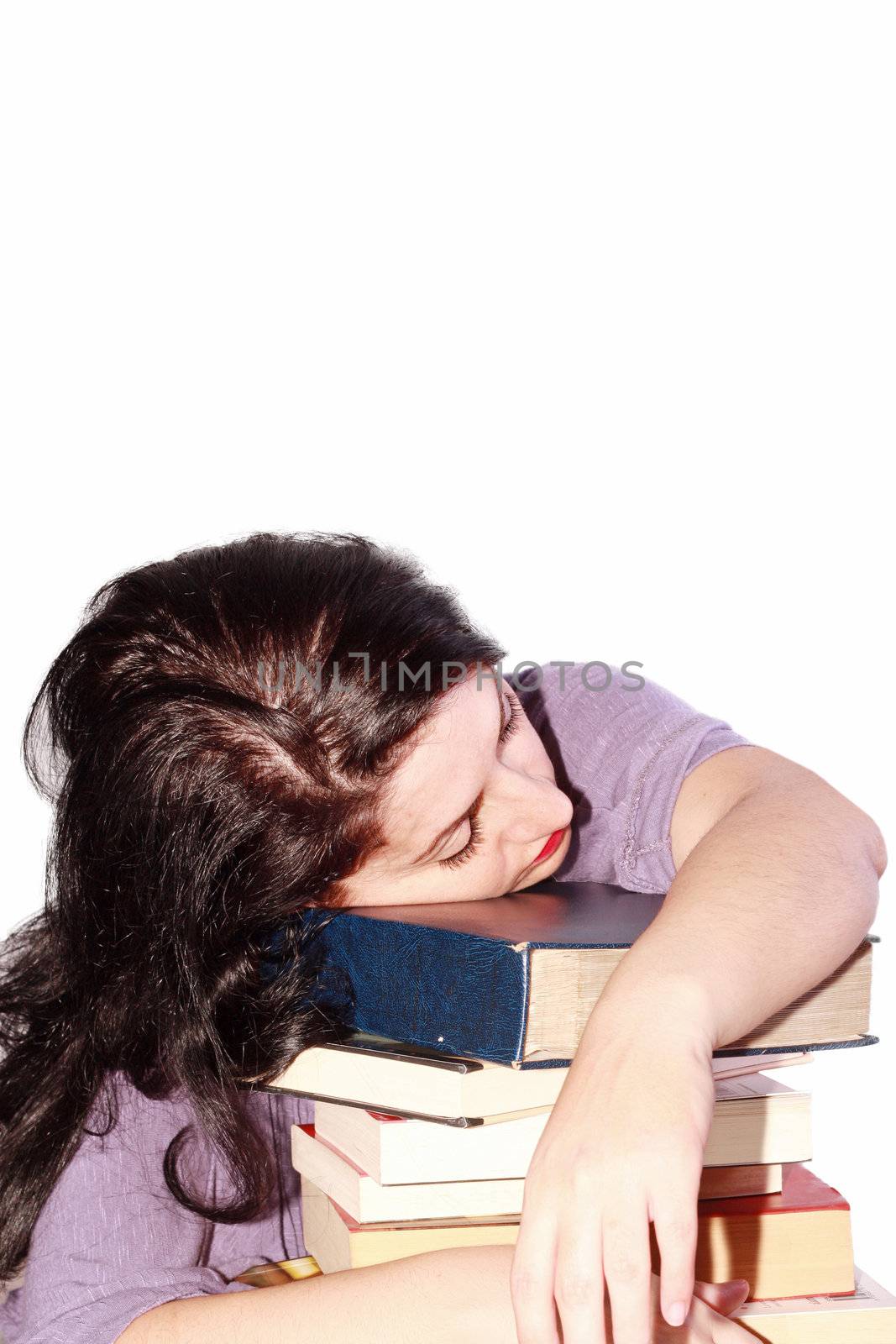 Young beautiful woman sleeping with books in a white background