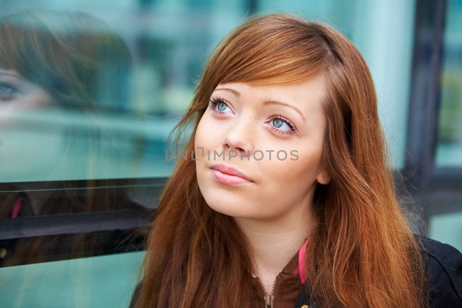 Portrait of teenage girl in outdoor location, looking up