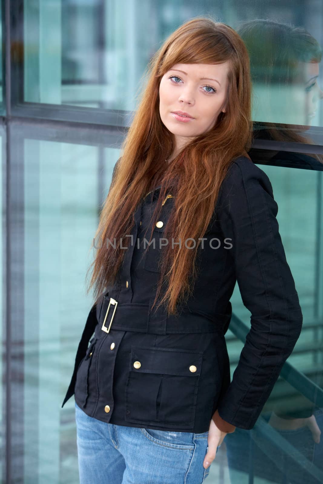 Portrait of teenage girl in outdoor location, leaning to wall