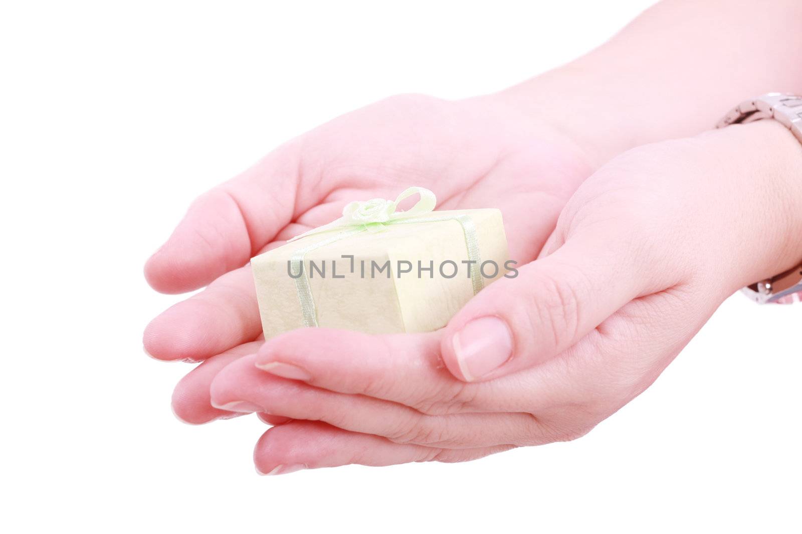 Female hands giving a gift. Isolated on white by dacasdo