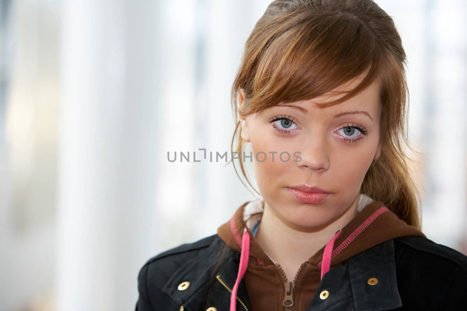 Teenage girl in modern building, front view