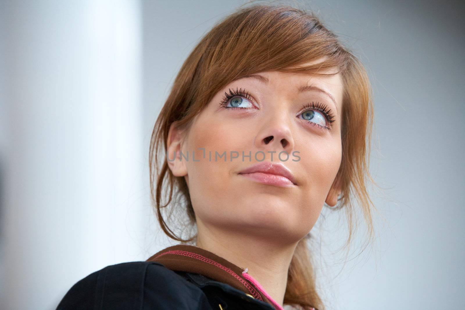 Teenage girl in modern building, looking up