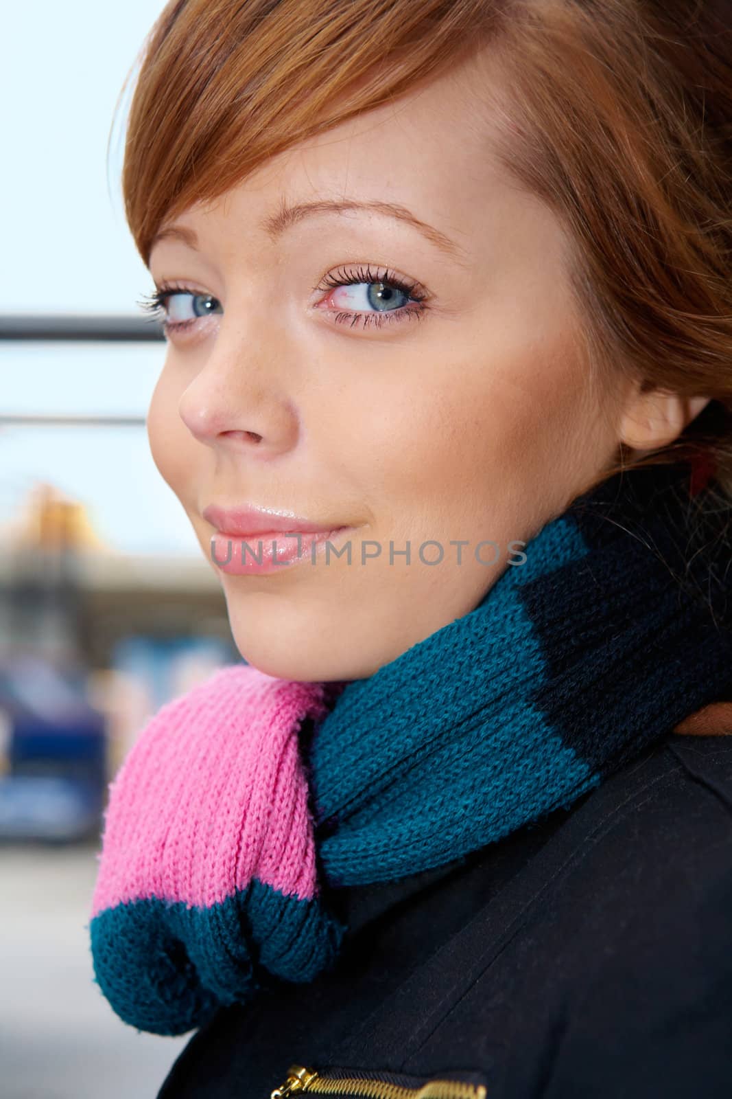 Teenage girl wearing scarf, smiling, looking at camera