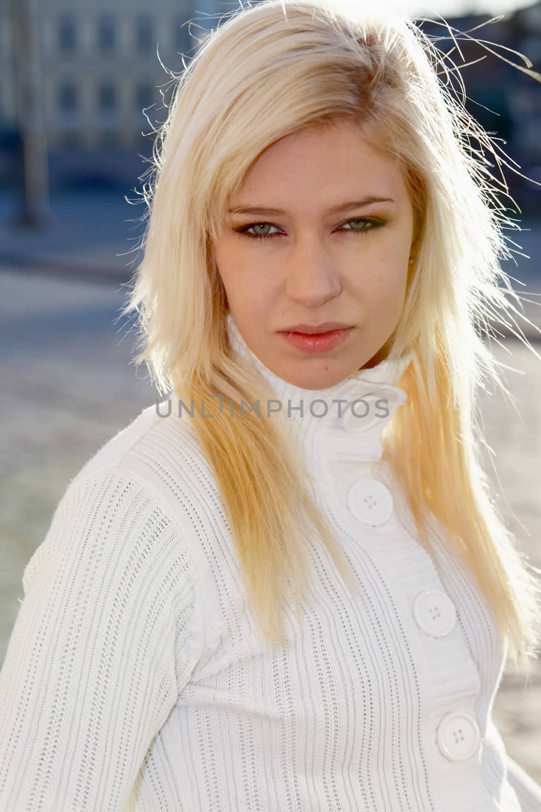 Teenage girl looking at camera, exterior in city