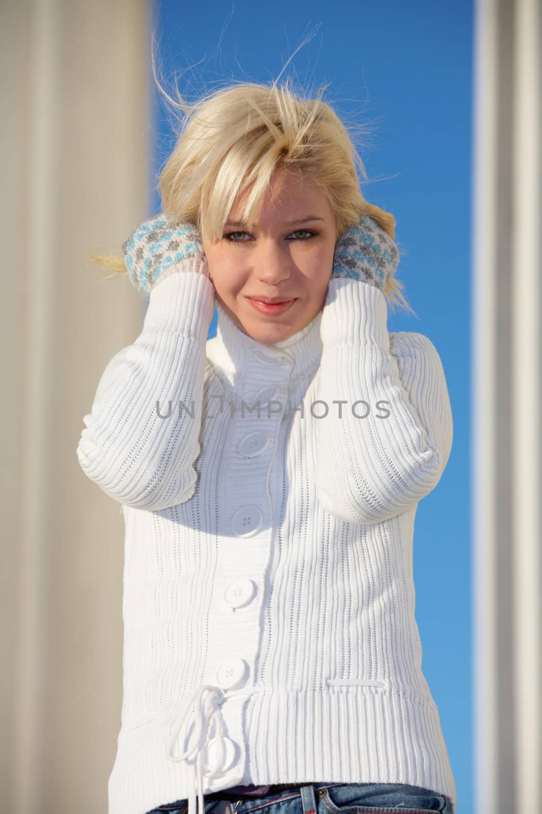 Teenage girl holding her hair, looking at camera
