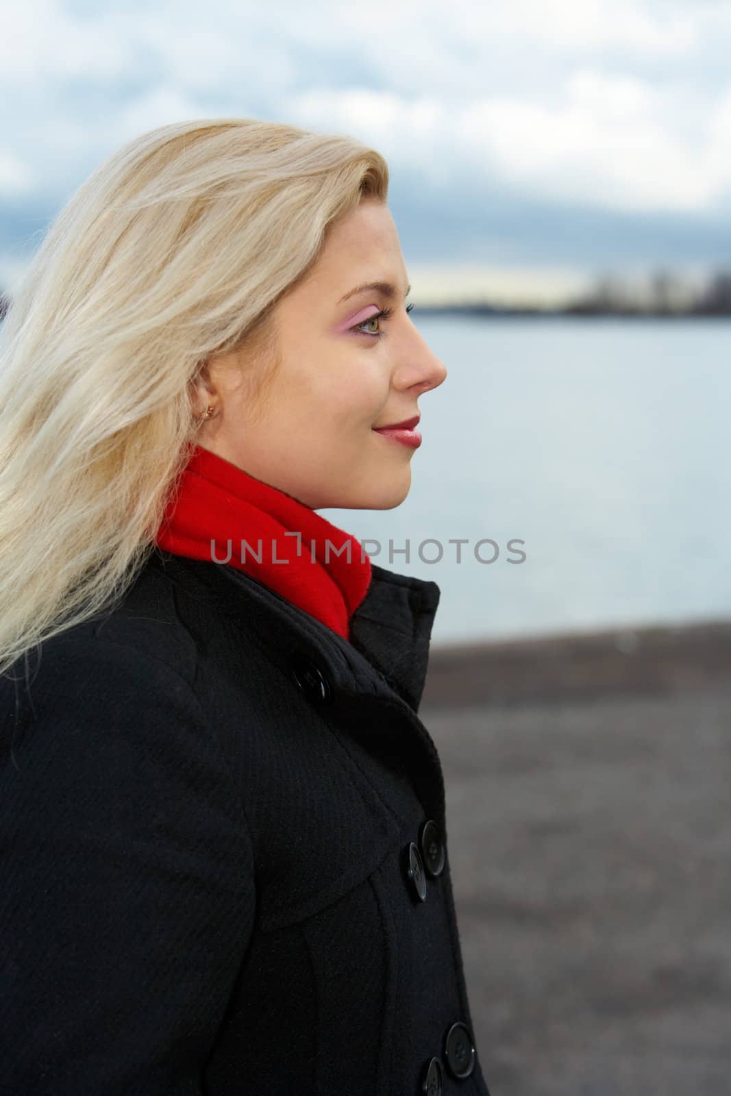 Young woman contemplating outdoors, side profile 