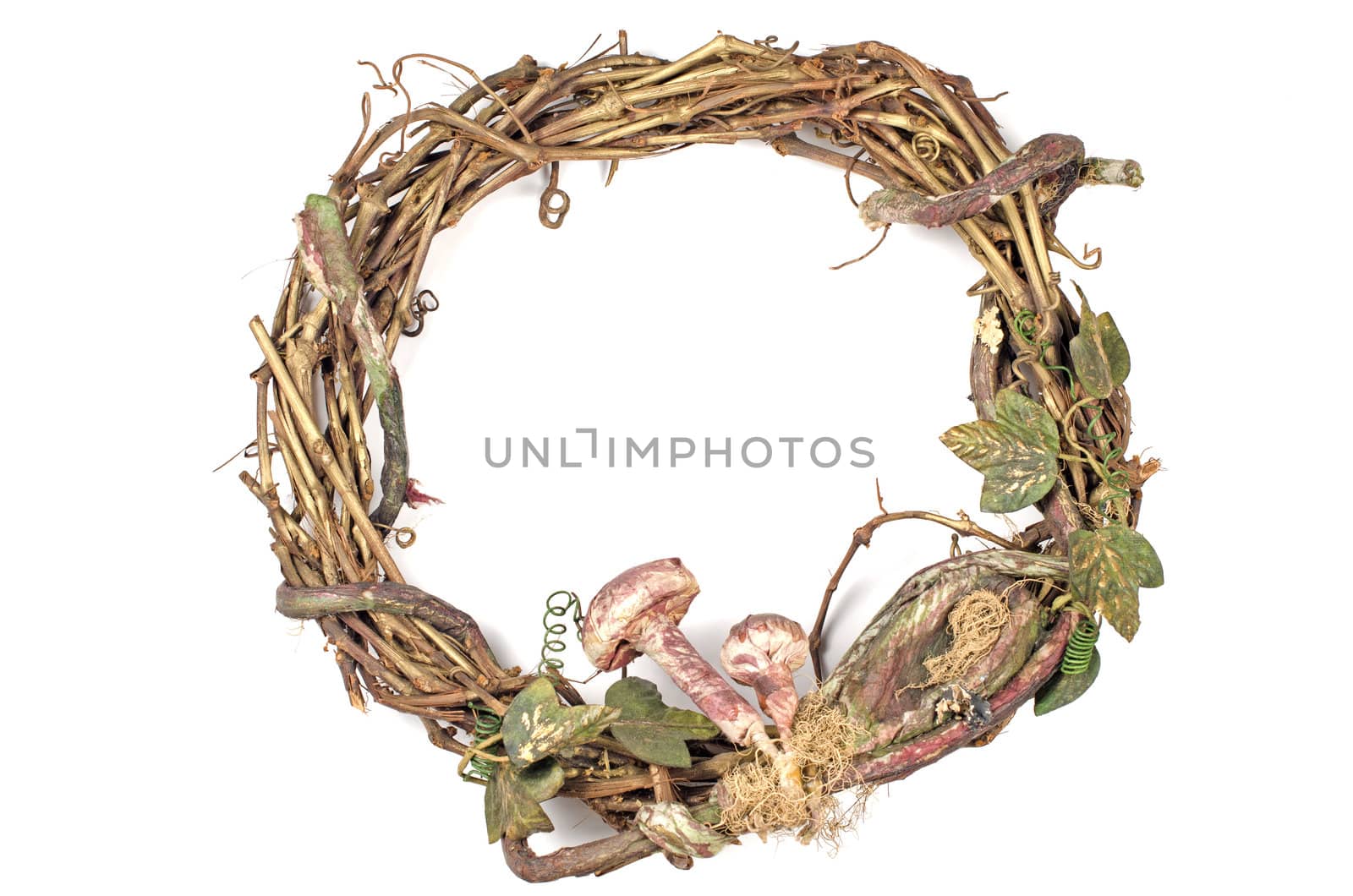 Wreath made with straw and mushrooms on white background.
