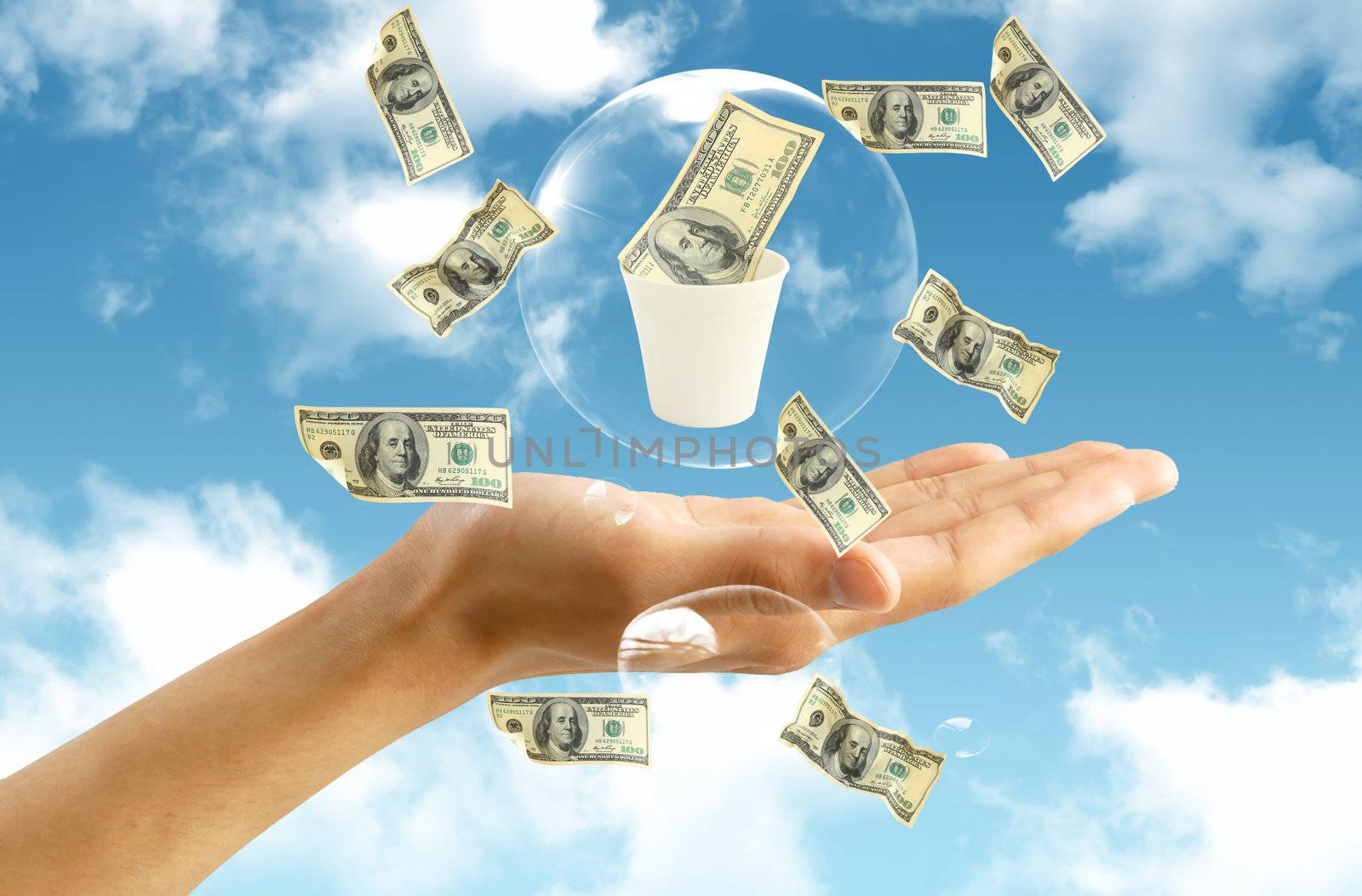 american dollar in hand on blue sky background by rufous