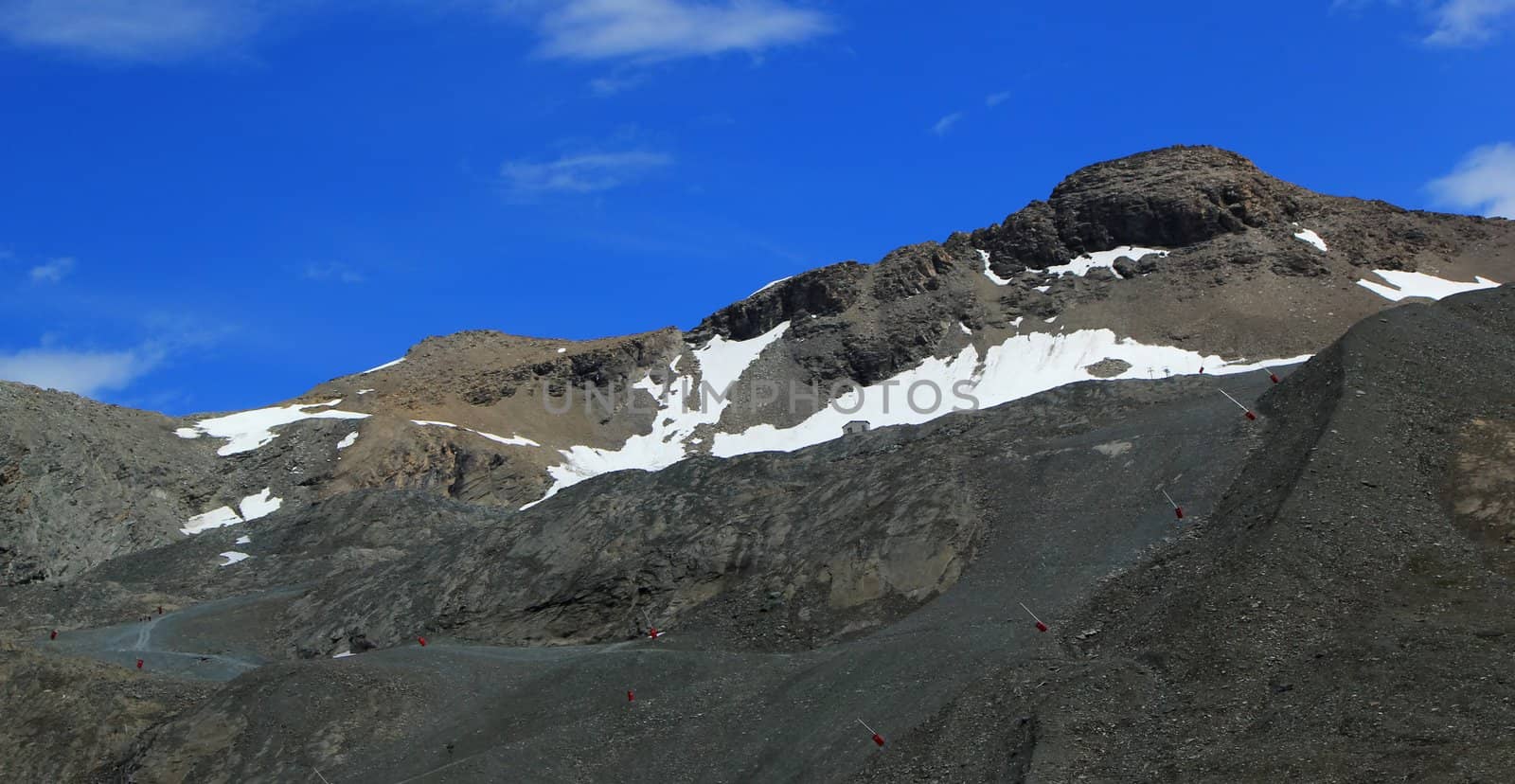 Top of french Alps mountain with snow neve by summer