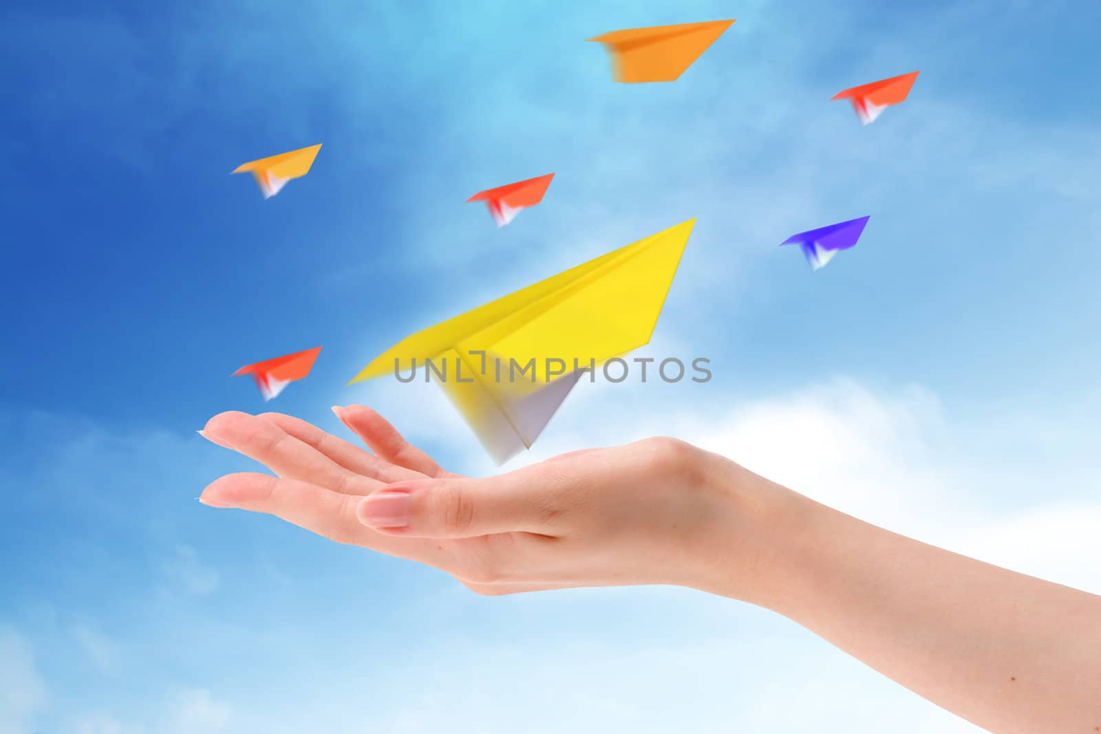 Throwing a paper plane in the sky. Freedom, success,   by rufous