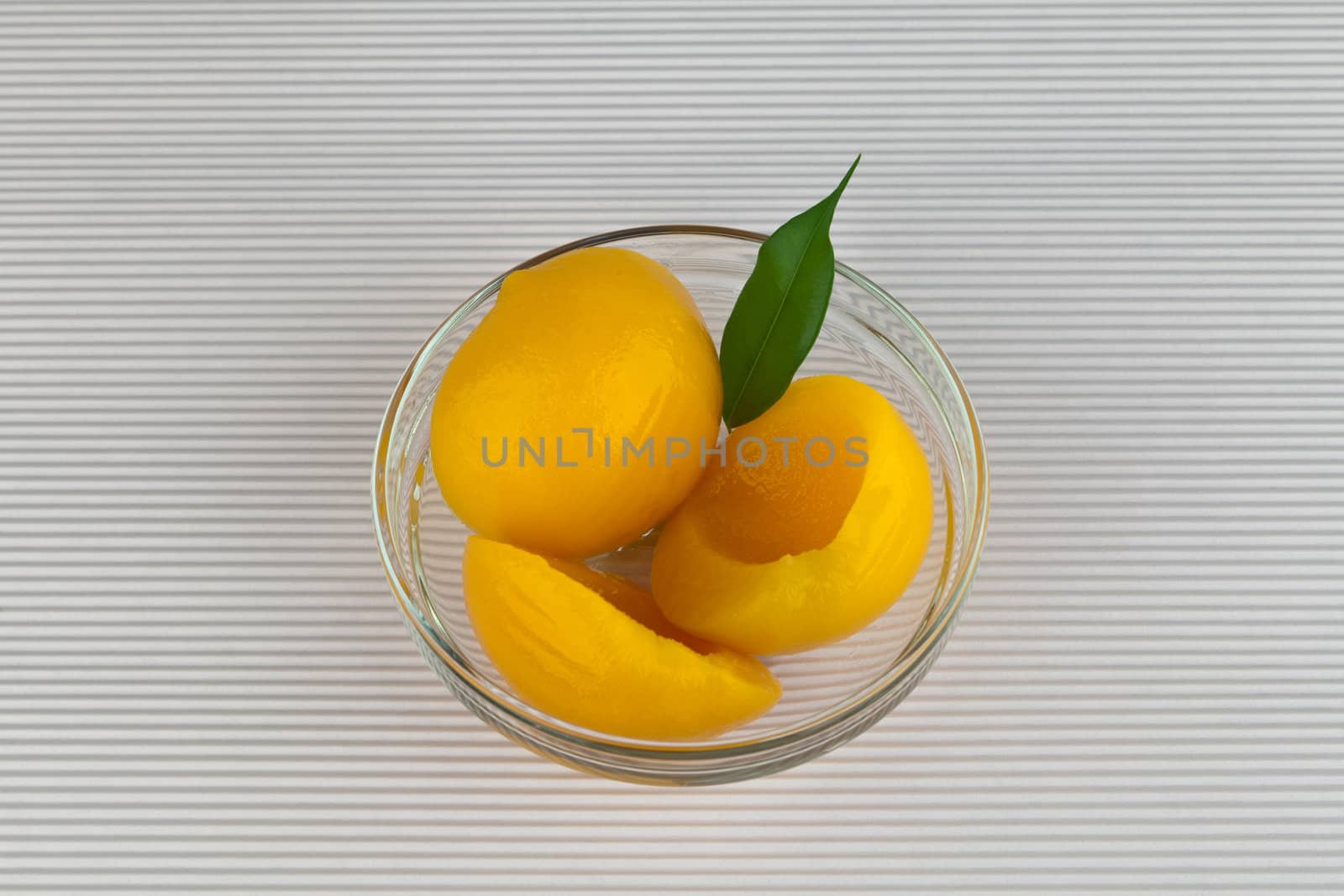 Canned Peaches in sweet syrup on  glass jar.