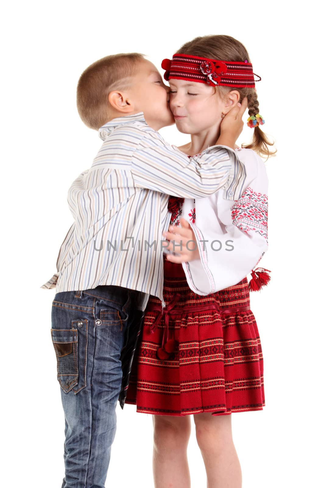 Little boy kissing a little girl on the white background
