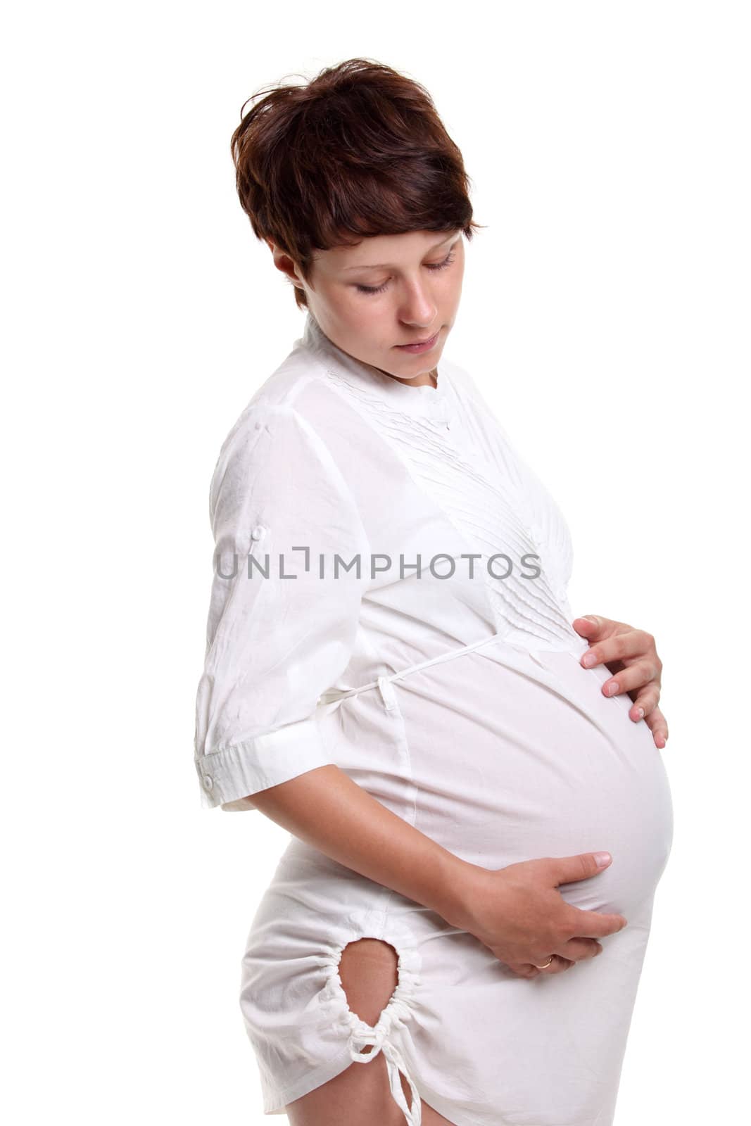 Pregnant young woman in a white shirt on the white background
