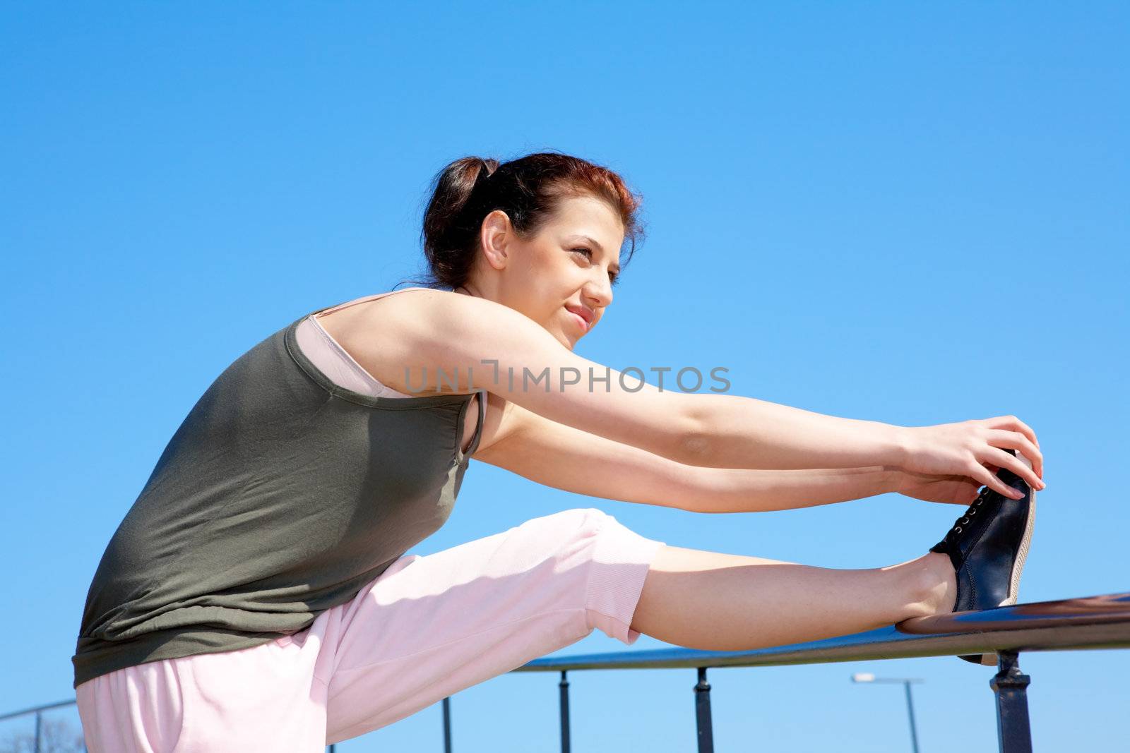 Teenage girl jogging stretching her legs