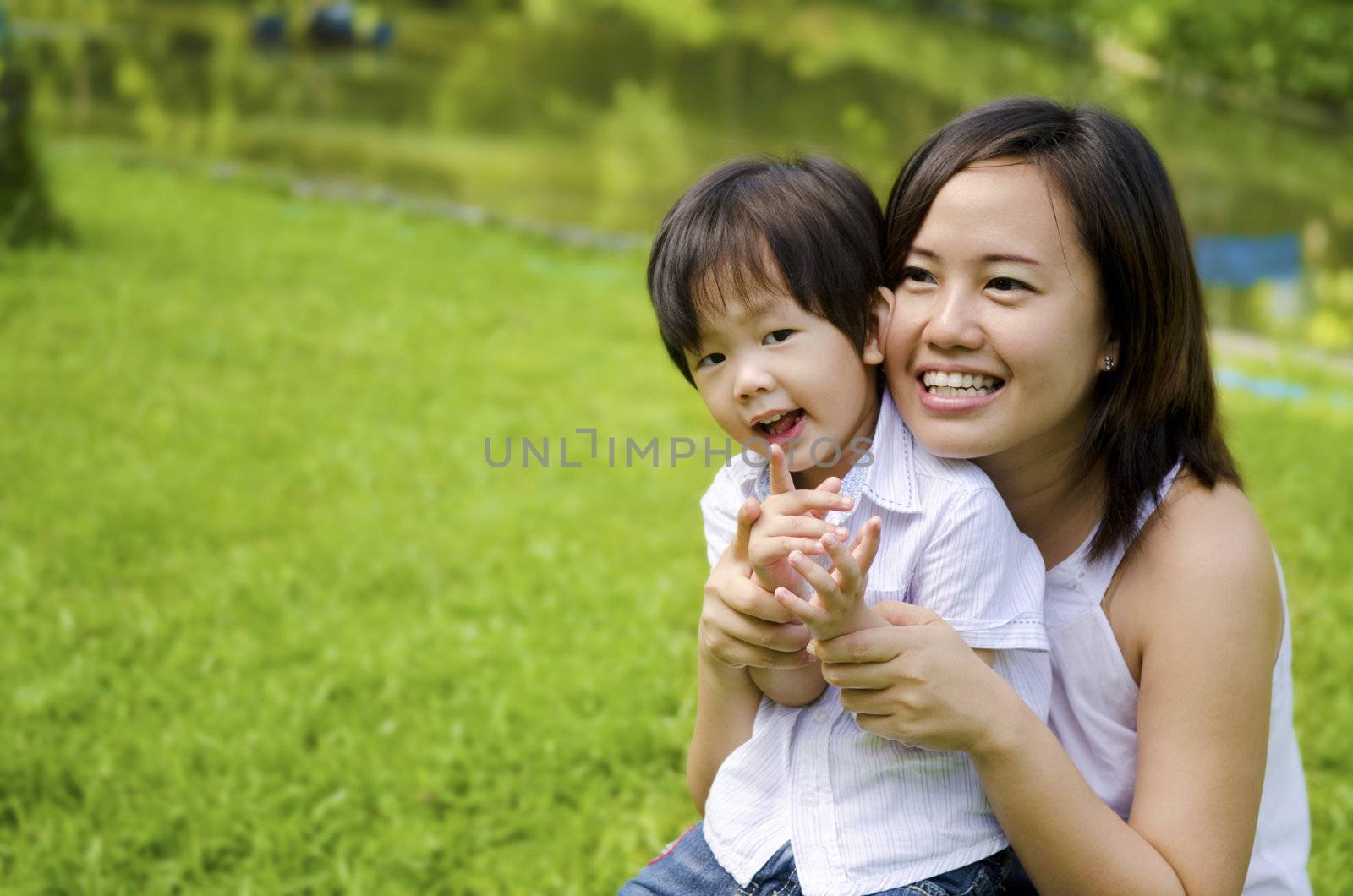 Outdoor park happy Asian mother and son