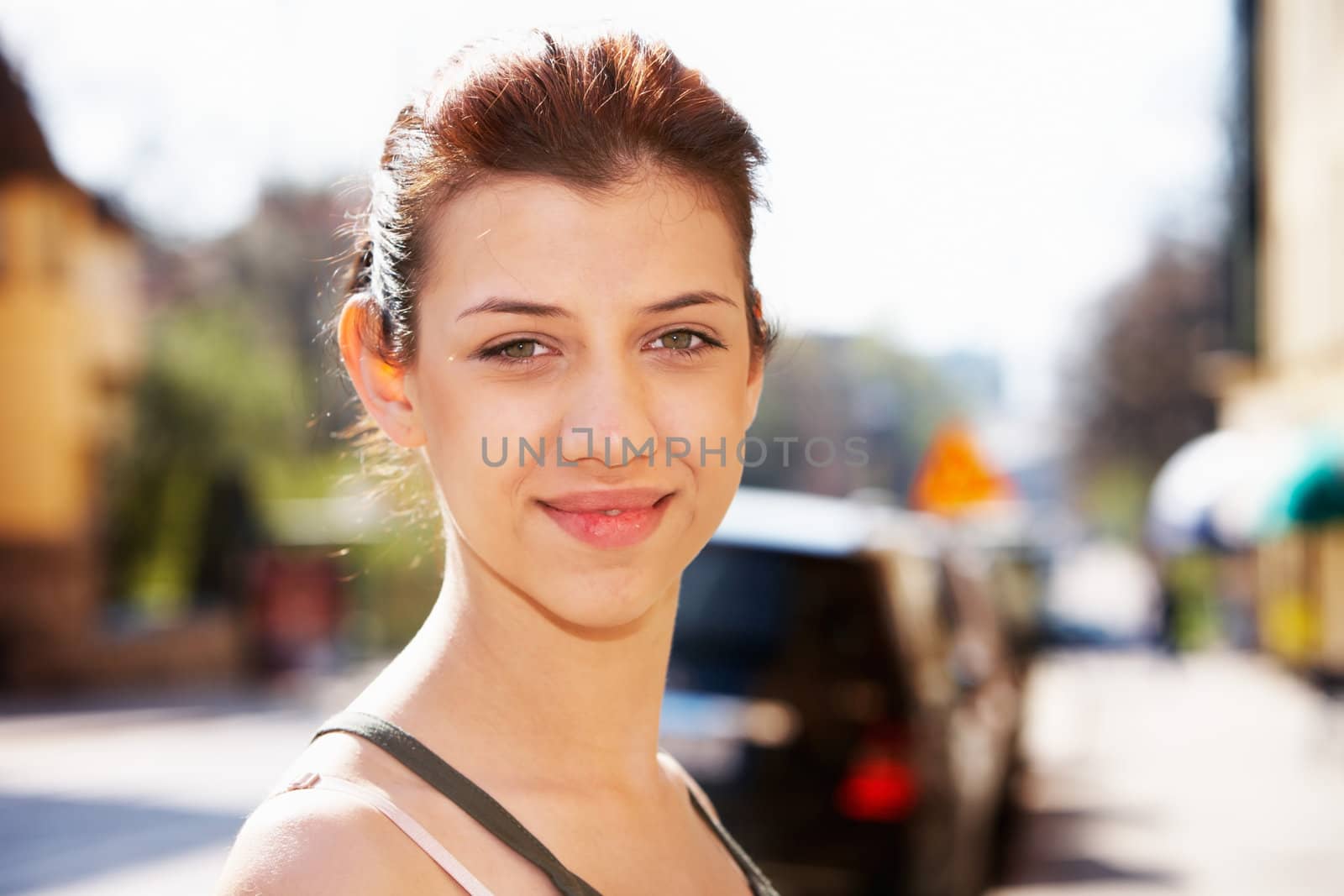 Teenage girl in street looking at camera, close-up