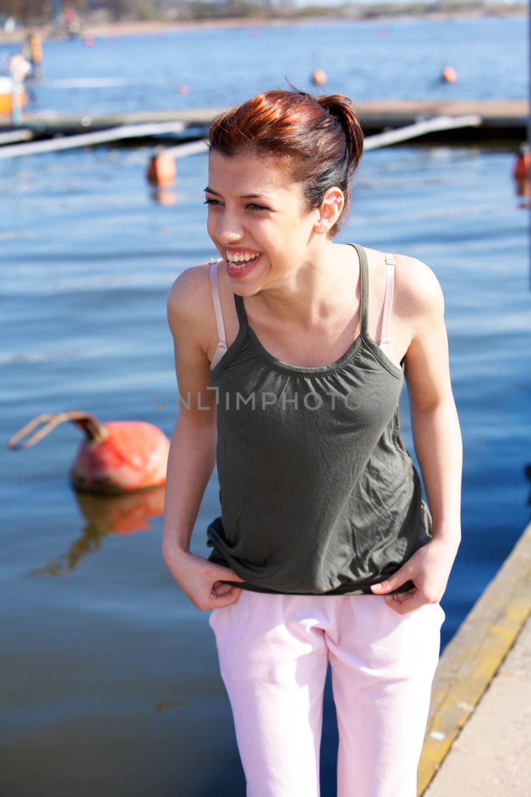 Portrait of teenage girl outdoors, laughing