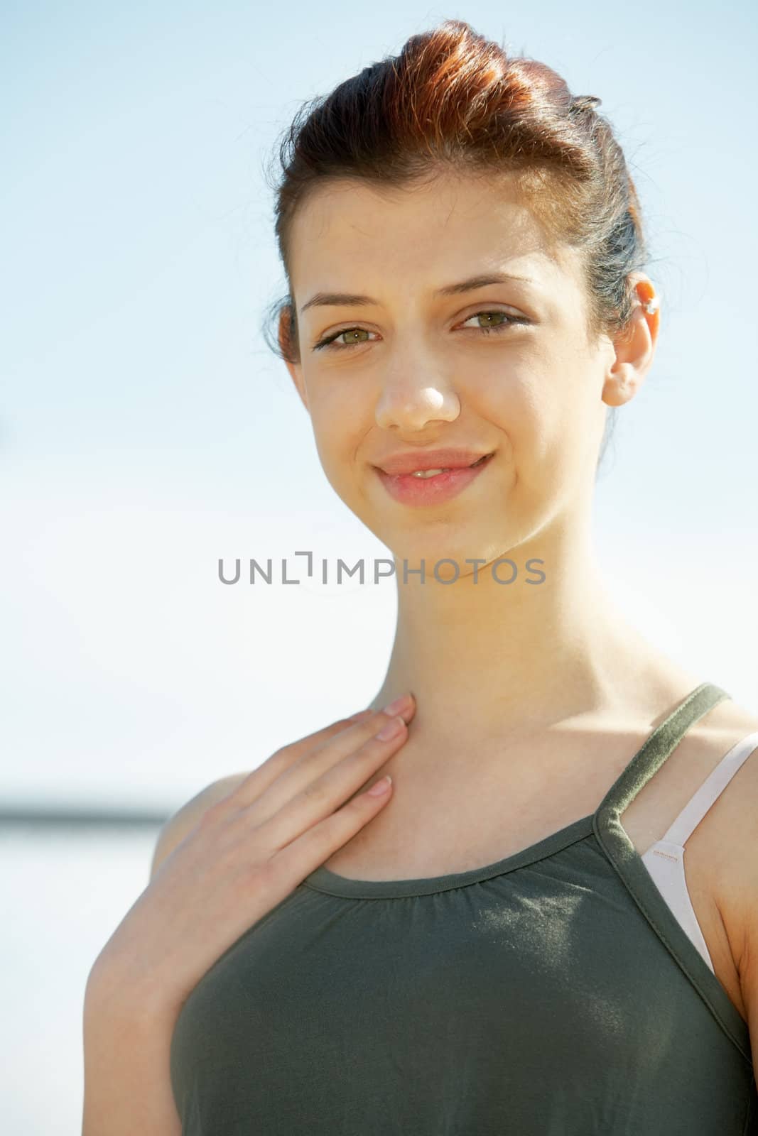 Teenage girl outdoors, looking at camera smiling