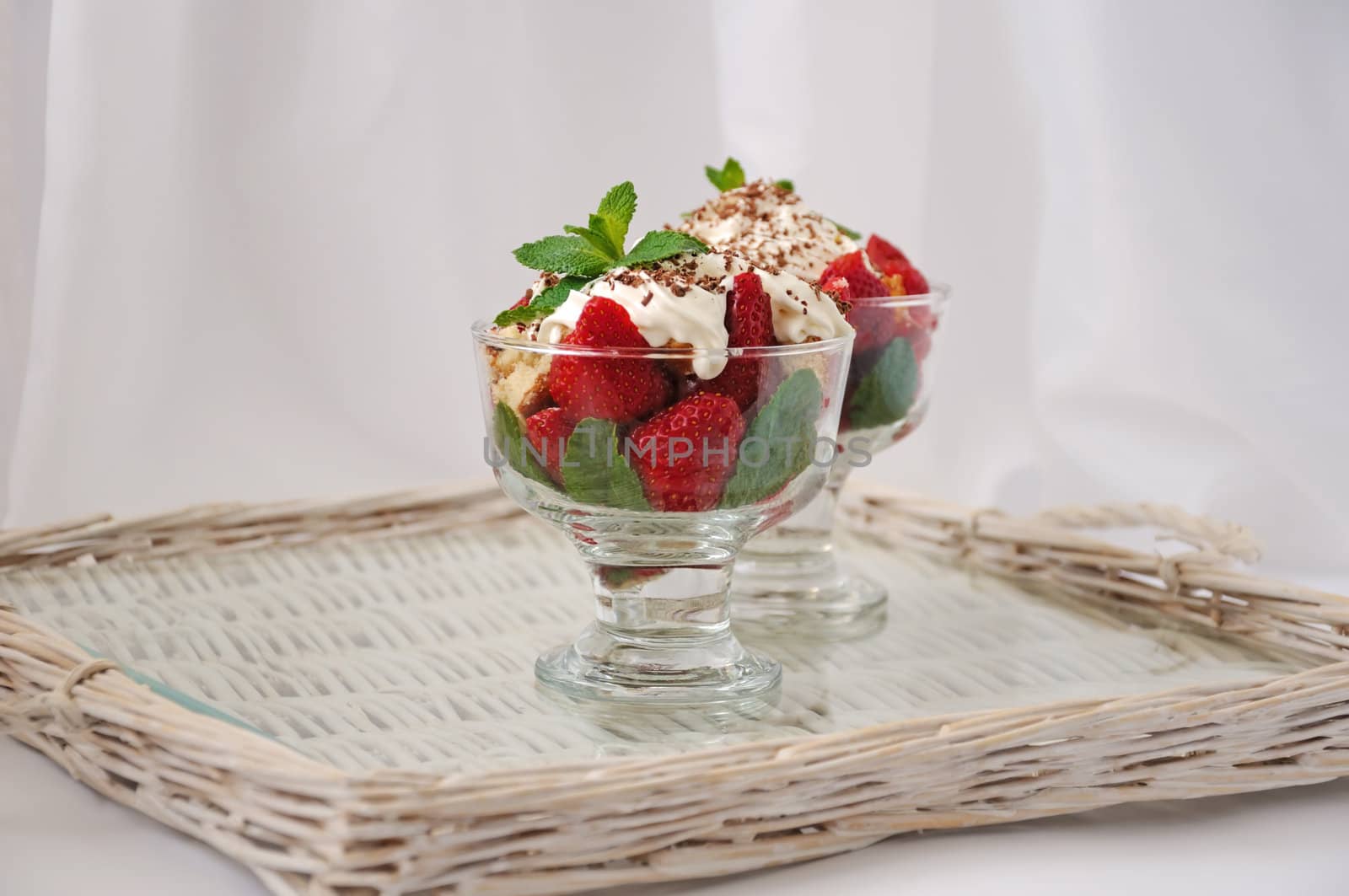 Strawberries with biscuit pieces with mint whipped cream under by Apolonia