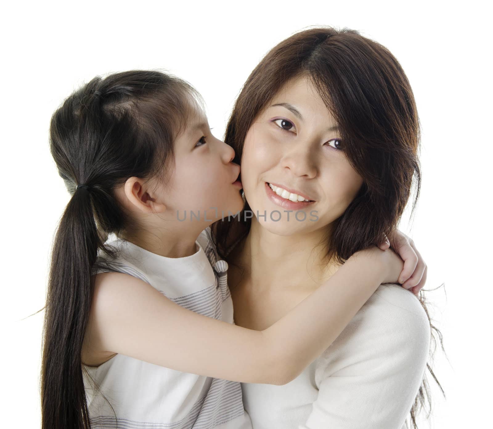 Happy Asian daughter kissing her mother on white background