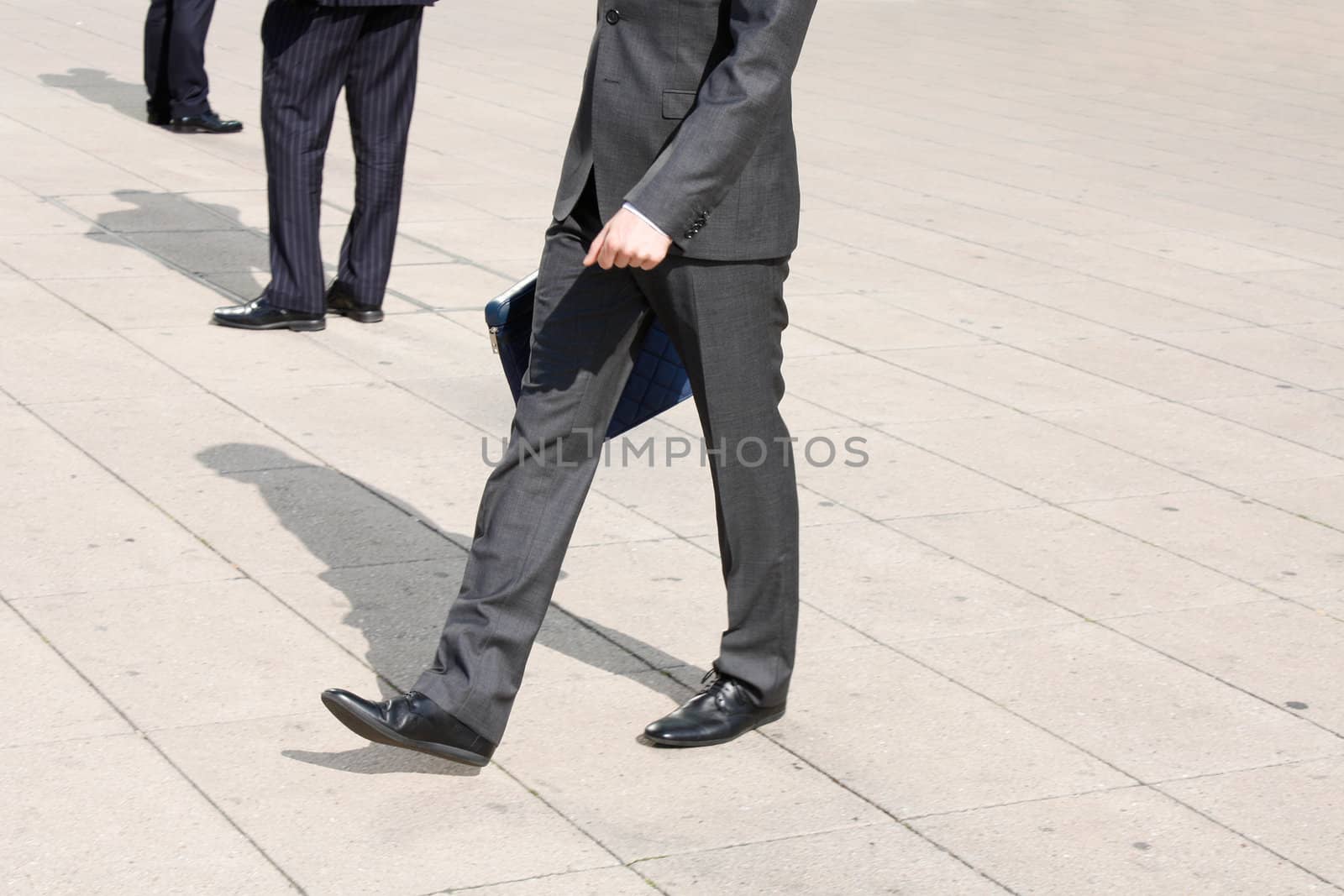 Business men walking on the pavement