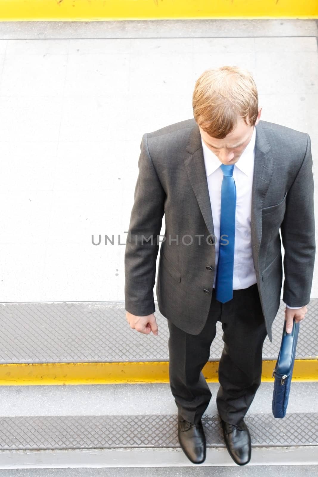 A business man walking down some steps