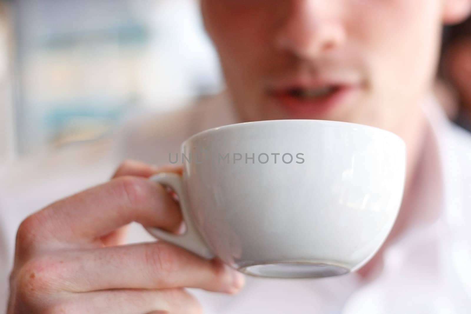 A man drinking coffee in a cafe