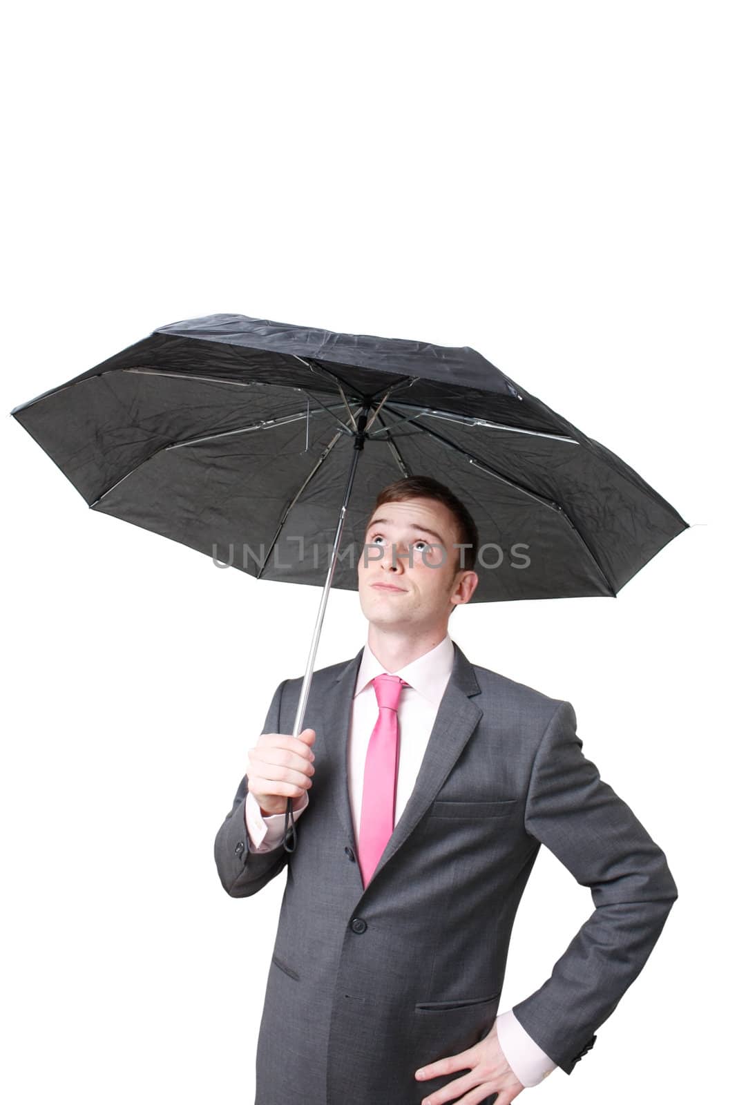 A business man hiding under an umbrella
