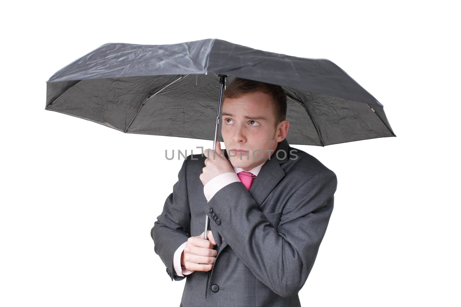 A business man hiding under an umbrella