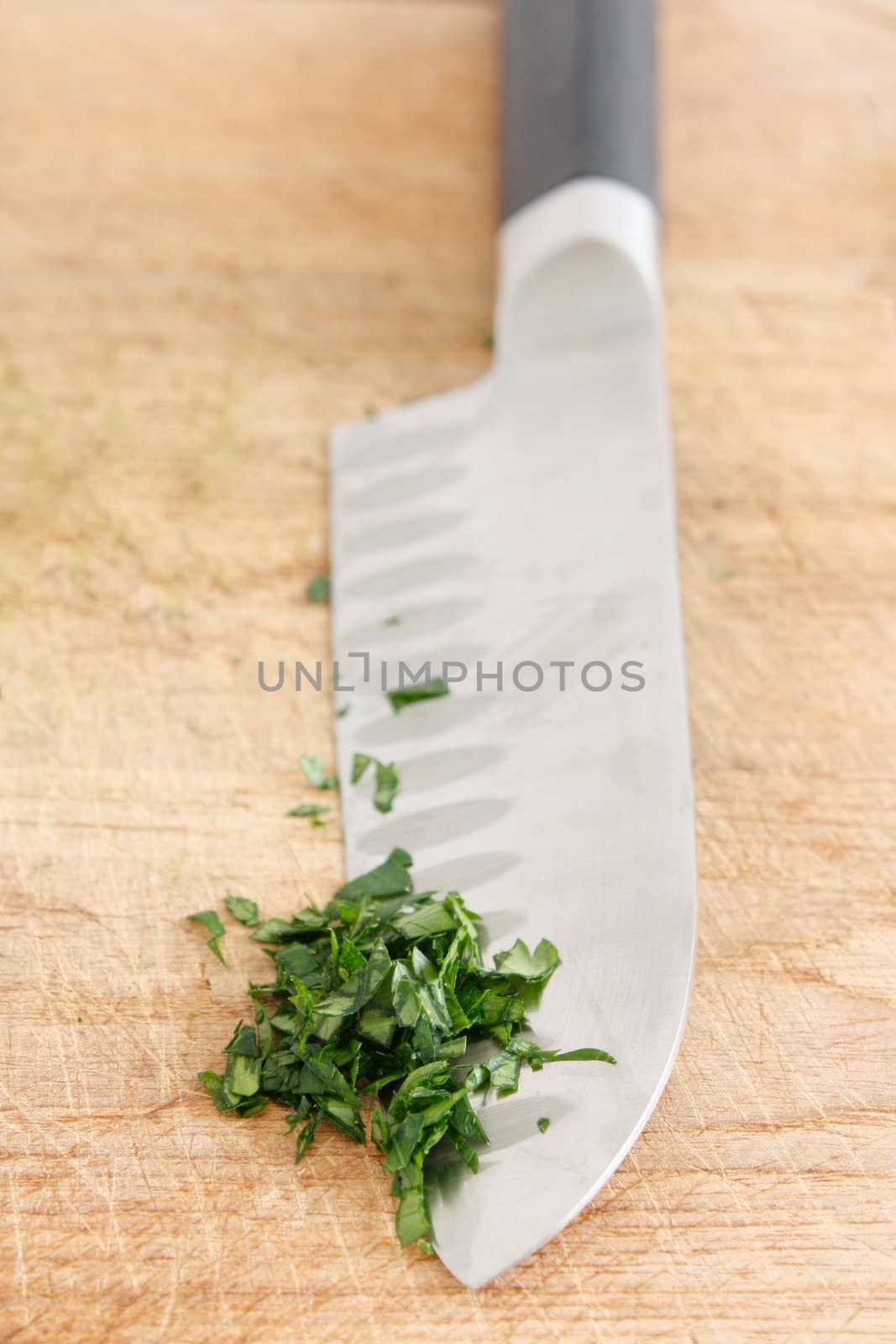 Chopping parsley on a wooden surface