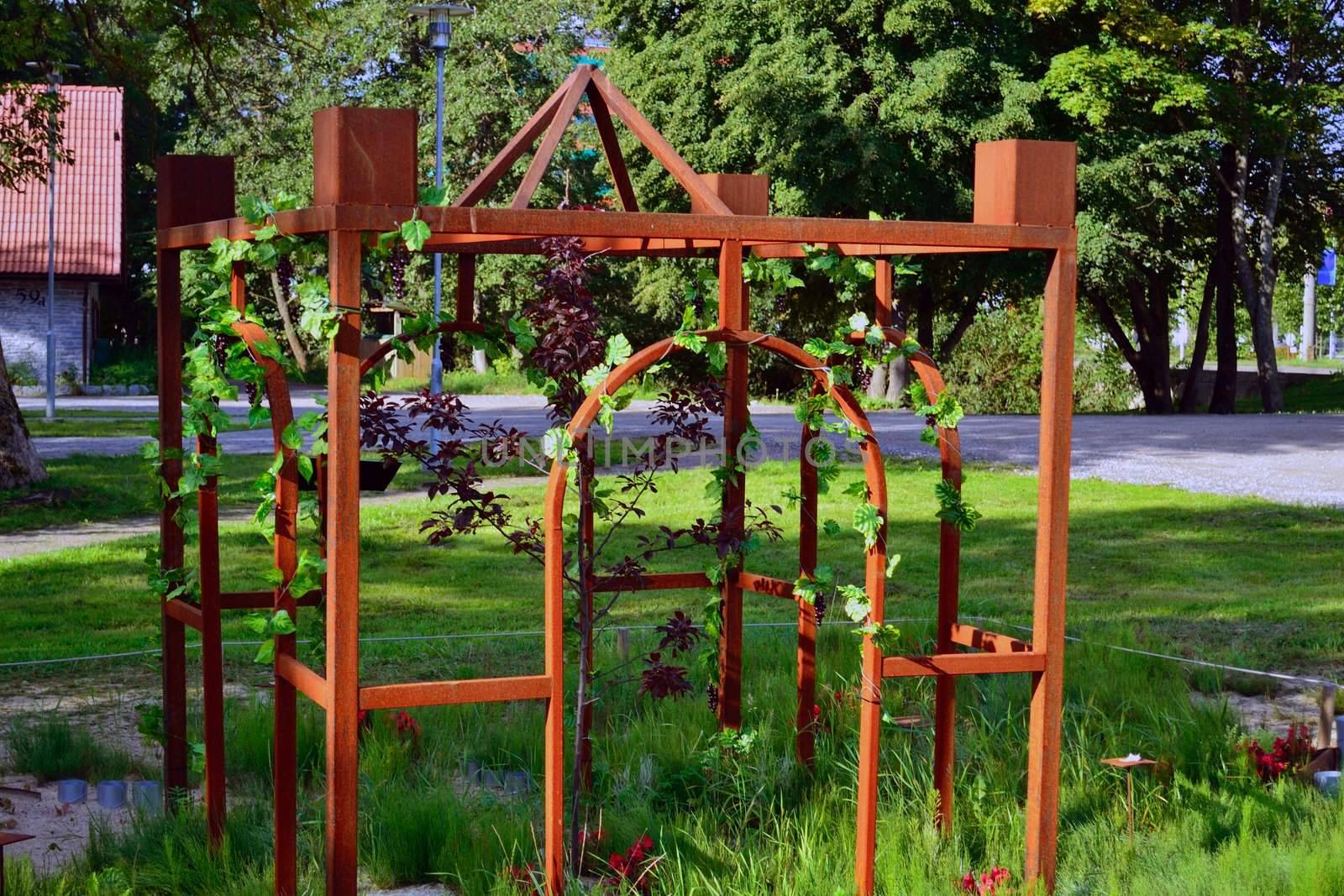 green garden with wrought iron arbor