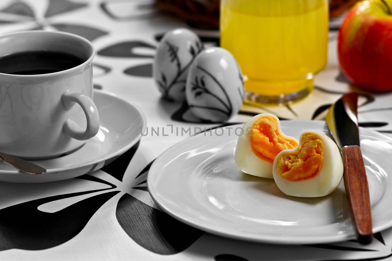Breakfast with heart shaped egg, coffee, orange juice and an apple