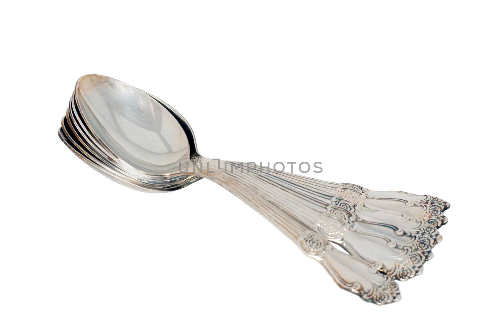 Old silver spoons on white background