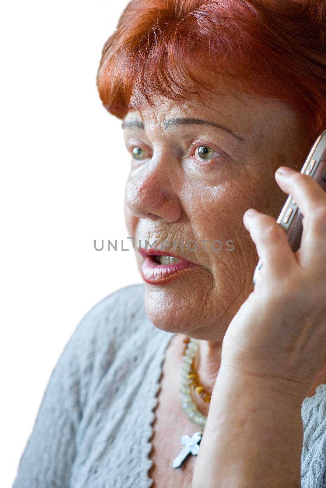 Frightened senior woman with cellphone by kzen