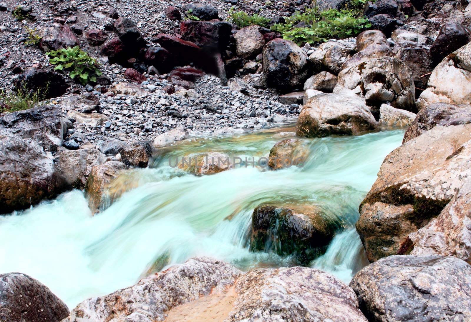 fast clear mountain river between big stones