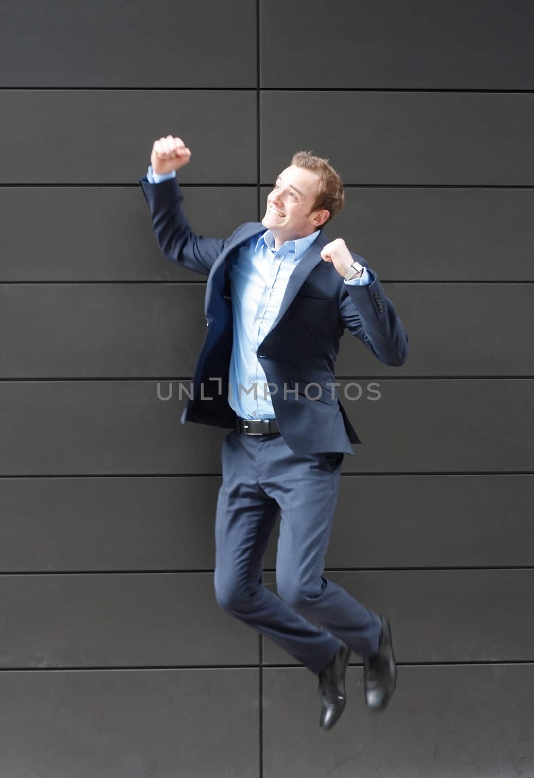 Business man jumping by leeser