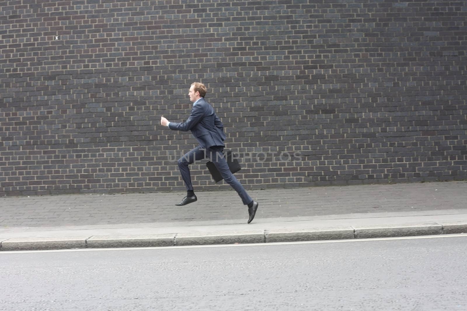 Business man running by leeser