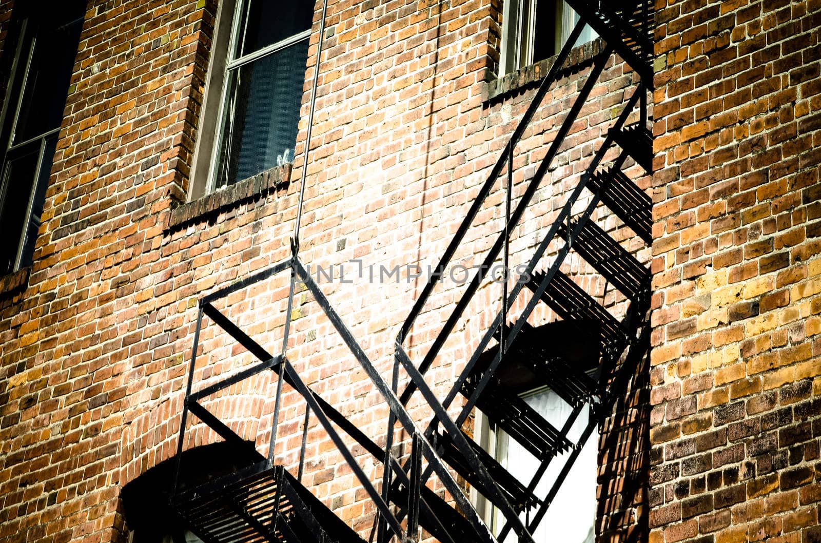 an old bricks building and black fire escape stairs