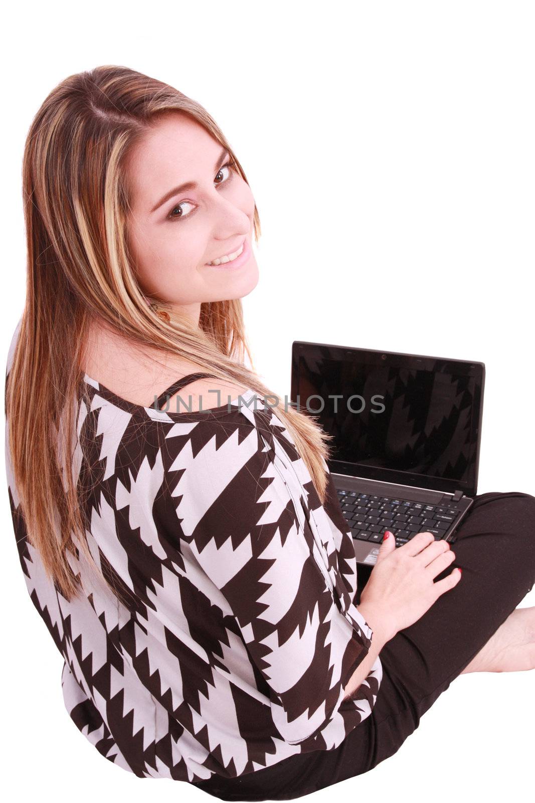 Happy young woman using laptop while sittingg on floor. Isolated on white. Top view.