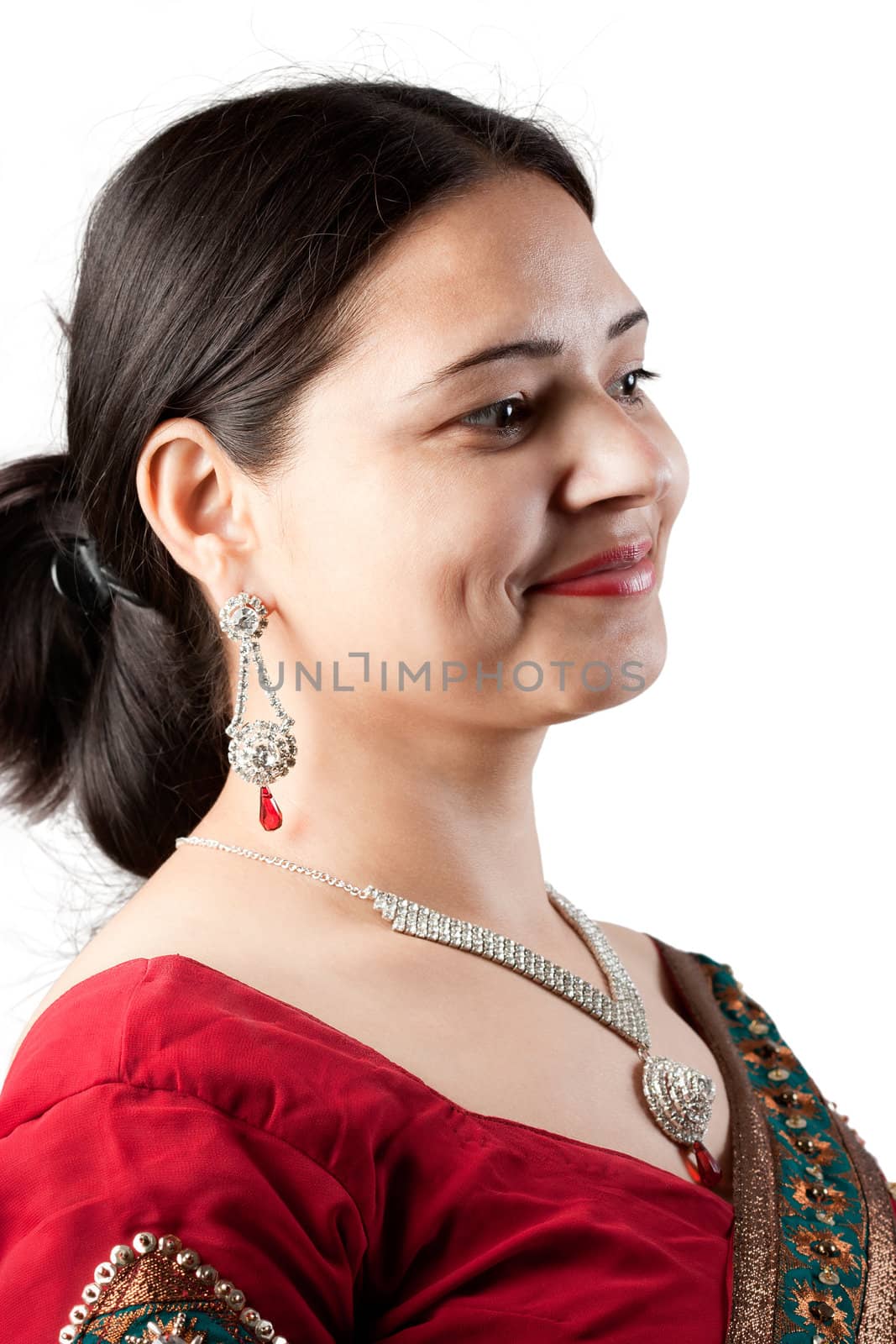 Smiling Indian happy woman wearing  beautifully embroidered red sari