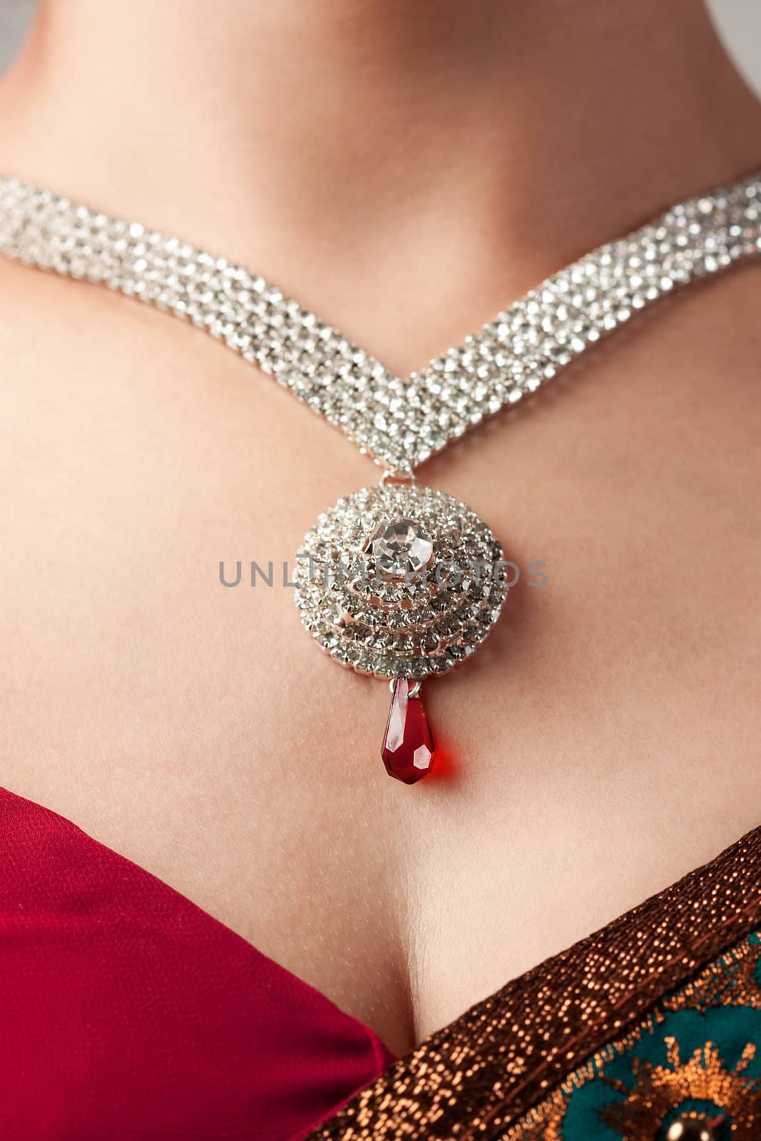 Close up of diamond necklace over female body skin