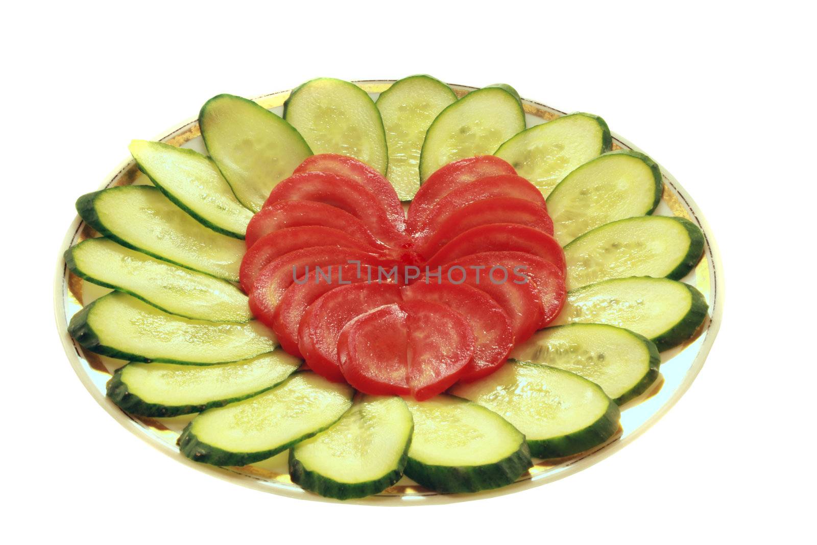 a dish with cucumbers ant tomatoes on the white backgtound