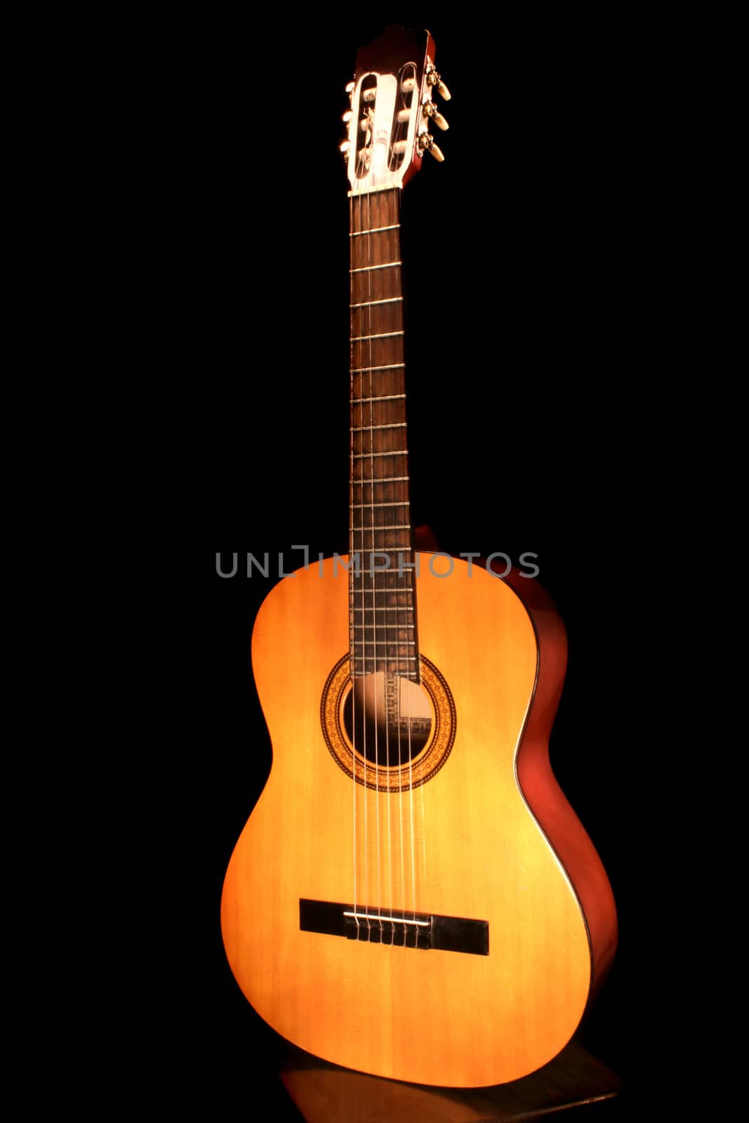 the acoustic guitar on the black background