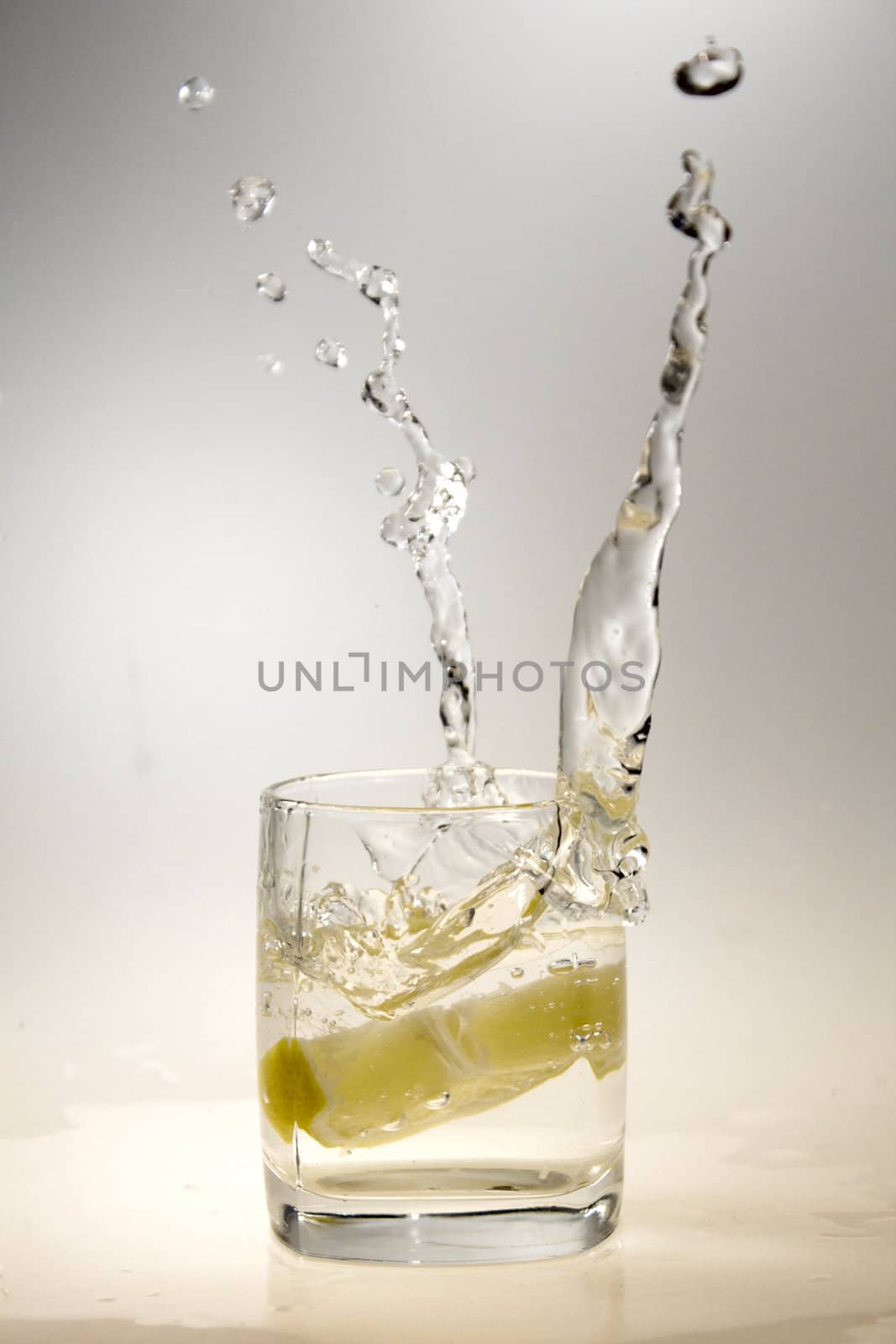 a glass of water and a lemon