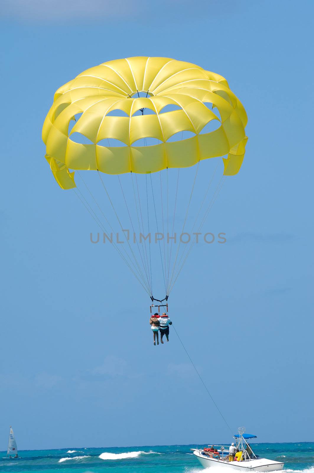 A couple are parasailing over the caribbean sea. The Dominican Republic, Punta Cana.