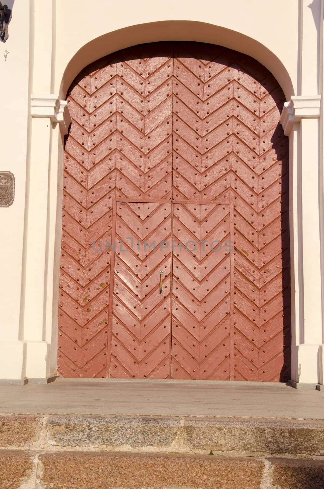 Interesting old brown door inserted into the arch.