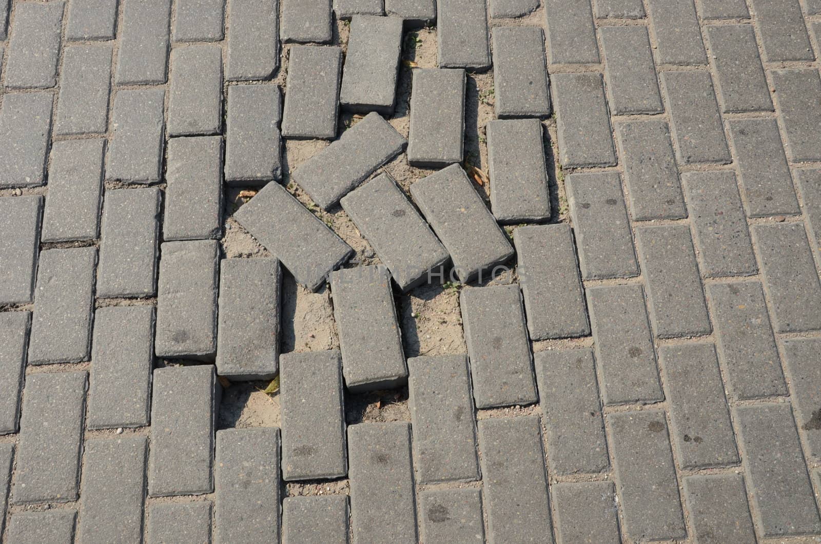 Small tiled sidewalk. Few stolen ones. Background.