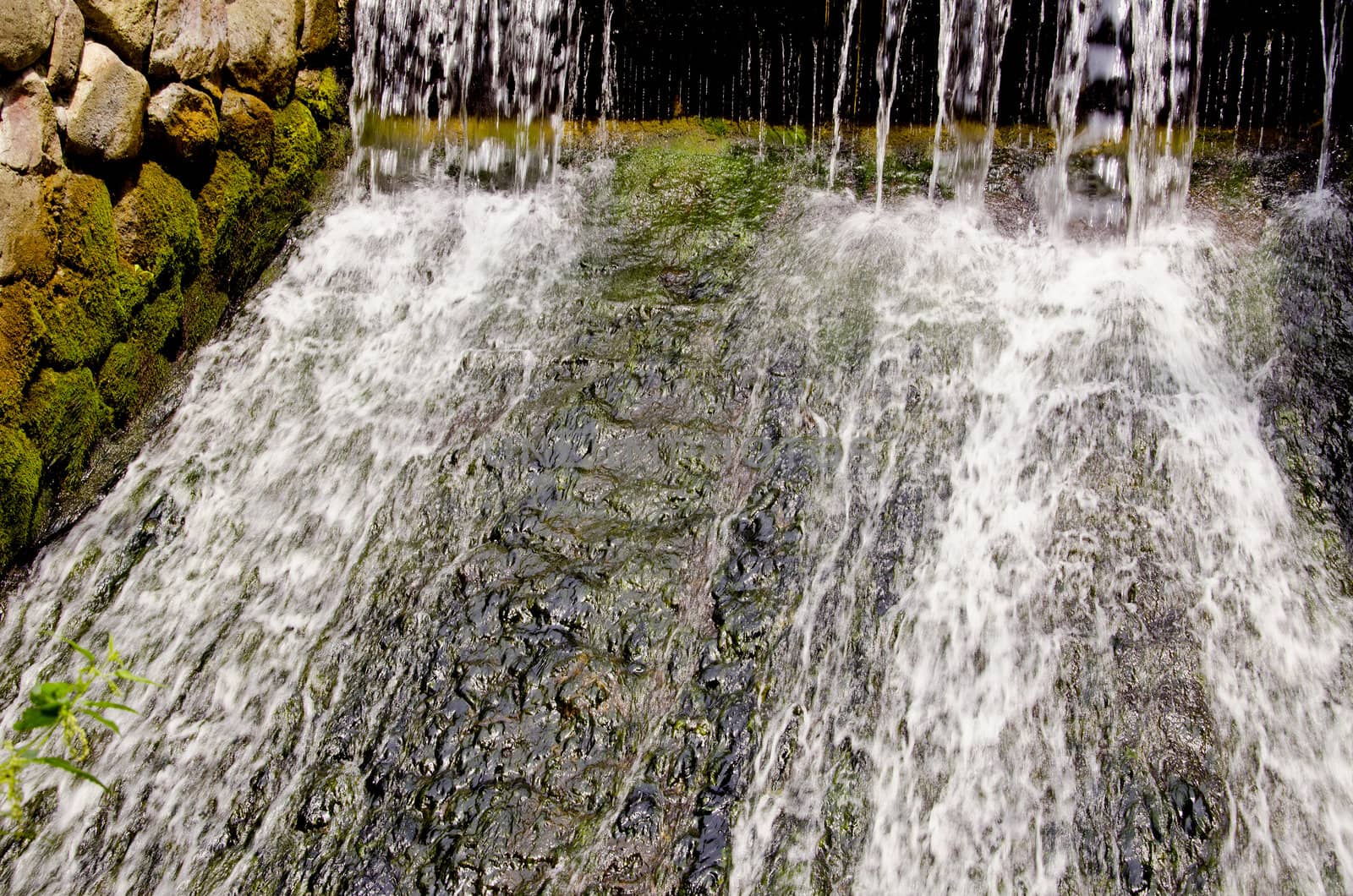 Water falling and flowing. Nice waterfall and old stones view.