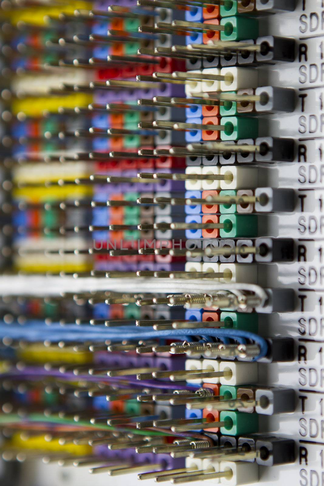 Telecommunications wire panel, mostly empty wire pins shows telecom industries standard colors.